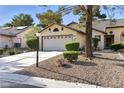 Lovely single-story home showcasing a spacious driveway, two-car garage, and desert landscaping at 4908 Winterset Dr, Las Vegas, NV 89130