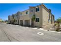 A row of townhomes showcases well-maintained landscaping and convenient garage access at 5617 Craftsman Ave, Las Vegas, NV 89122