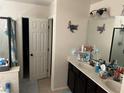 Bathroom with dual sinks, attractive countertops, and decorative turtle artwork at 7064 Coventry Glenn Rd, Las Vegas, NV 89148