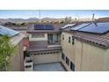 An aerial view shows the home with solar panels, a small balcony and a tile roof at 8325 Winterchase Pl, Las Vegas, NV 89143