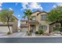 Two-story home with desert landscaping, attached two-car garage, neutral color palette and covered entryway at 8325 Winterchase Pl, Las Vegas, NV 89143