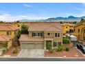Beautiful two-story home with a three-car garage, mountain views, and desert landscaping at 8929 Monte Oro Dr, Las Vegas, NV 89131