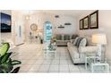 The open floor plan highlights the bright living room with its white tile flooring and modern furniture at 2093 Seahurst Dr, Las Vegas, NV 89142