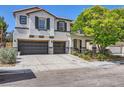 Stunning two-story home boasting a three-car garage, landscaped yard, and elegant stucco exterior with stone accents at 2608 Prospector Mine Ave, North Las Vegas, NV 89031