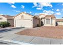 Inviting single-story home showcasing a garage, desert landscape, and traditional architectural details under a sunny sky at 3340 N Campbell Rd, Las Vegas, NV 89129