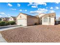 Beautiful single-story home with a garage, desert landscaping, and classic architectural features under a clear blue sky at 3340 N Campbell Rd, Las Vegas, NV 89129