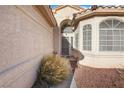 Home's entry featuring an arched entryway, security screen door, decorative windows, and low-maintenance landscaping at 3340 N Campbell Rd, Las Vegas, NV 89129