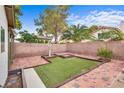 Private backyard featuring unique grass squares and brick pavers, perfect for relaxation and entertaining at 4630 Pratt Way, Las Vegas, NV 89147
