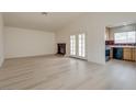 Bright and airy living room features new flooring, high ceilings, fireplace, and view into kitchen at 4630 Pratt Way, Las Vegas, NV 89147