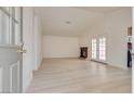 Bright and airy living room features new flooring, high ceilings, fireplace, and patio access at 4630 Pratt Way, Las Vegas, NV 89147