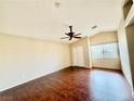 Bedroom showcasing hardwood floors, a ceiling fan, and a double-door closet at 5517 Overlook Valley St, North Las Vegas, NV 89081