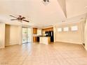 Open-concept living space with tile floors, ceiling fan, and sliding doors to the outdoor patio at 5517 Overlook Valley St, North Las Vegas, NV 89081