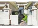 Charming front entrance with decorative iron gate, stone pillars, and a brick pathway at 613 Pinnacle Heights Ln, Las Vegas, NV 89144