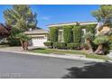 Well maintained single-story home with manicured landscaping, palm trees, and an attached two-car garage at 613 Pinnacle Heights Ln, Las Vegas, NV 89144