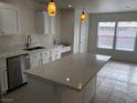 Bright kitchen with white cabinets, stainless steel appliances, and large island with white quartz countertops at 6449 Elizabethtown Ave, Las Vegas, NV 89110
