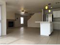 Open-concept living area with a fireplace and tile flooring, seamlessly connecting the kitchen and living spaces at 6449 Elizabethtown Ave, Las Vegas, NV 89110