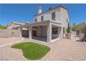 Spacious backyard featuring a covered patio and low-maintenance gravel landscaping at 6601 W Pepperidge Way, Las Vegas, NV 89108