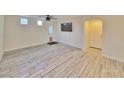 Open living room with stylish tile flooring, a ceiling fan, and access to the backyard at 6621 Churnet Valley Ave, Las Vegas, NV 89139
