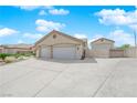 Features a wide driveway leading to a two-car garage and an adjacent gated area at 6781 Alpine Brooks Ave, Las Vegas, NV 89130