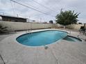Inviting backyard pool with a jacuzzi, surrounded by a concrete deck and privacy fence at 1338 Smoke Tree Ave, Las Vegas, NV 89108