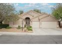 Inviting single-story home with a beautifully landscaped yard and a spacious driveway at 1598 Cowboy Chaps Pl, Henderson, NV 89002