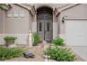 Up-close view of the front door and front yard including landscaping at 1598 Cowboy Chaps Pl, Henderson, NV 89002