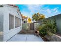 View of the private back yard with lush green plants and stucco wall at 2253 Van Gogh Dr, Henderson, NV 89074