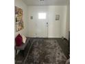 Bright entryway showcasing a rug, bench, artwork, and a white front door at 2755 Atomic Tangerine Way # 2, Las Vegas, NV 89183