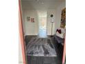 View of the entryway with a long hallway, rug, bench, and artwork on the walls at 2755 Atomic Tangerine Way # 2, Las Vegas, NV 89183
