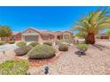 Charming single-story home with well-maintained desert landscaping, mature palm trees, and a two-car garage at 3001 Walnut Park Ct, Henderson, NV 89052