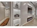 Modern living room with custom shelving, fireplace, and light wood flooring for a bright living space at 3001 Walnut Park Ct, Henderson, NV 89052