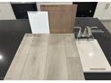 Interior design selection with gray vinyl plank, white quartz countertops, and brushed nickel faucet at 4205 Zilker Park Ave, North Las Vegas, NV 89081