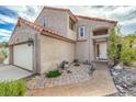 Charming two-story home with a well-maintained front yard with walkway leading to entrance at 56 Westheimer Rd, Henderson, NV 89074