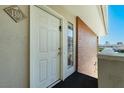 Close-up of unit 1310's front door, with a brick accent wall and exterior view at 698 Oakmont Ave # 1310, Las Vegas, NV 89109