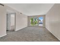 Spacious living room with neutral carpet and bright natural light from multiple large windows at 698 Oakmont Ave # 1310, Las Vegas, NV 89109
