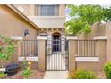 Close up of the gated front entry, showcasing the attractive landscaping and welcoming facade at 7013 Bisoni St, Las Vegas, NV 89149