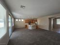 Spacious living room boasts an open layout and a kitchen with modern appliances at 7572 Coyote Cave Ave, Las Vegas, NV 89113