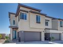 A modern two-story house with a gray garage door, neutral stucco exterior, and manicured landscaping at 860 Echelon St, Las Vegas, NV 89138