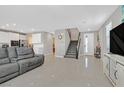 Spacious living room featuring glossy tile floors and an open floor plan, bathed in natural light at 949 Bayberry Ridge St, Henderson, NV 89052