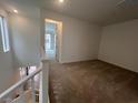 A bright loft space featuring neutral carpet, white walls, and natural light at 1515 Melodic Lark Dr, Las Vegas, NV 89138