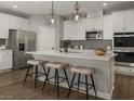 Eat-in kitchen with white cabinetry, stainless steel appliances, modern pendant lighting, and a central island at 1552 Pacific Baza St, Las Vegas, NV 89138