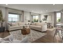 Spacious living room boasts neutral tones, stylish decor, and large windows offering plenty of natural light at 1552 Pacific Baza St, Las Vegas, NV 89138