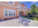 Inviting two-story townhome featuring a decorative paver patio and lawn at 2120 Waterlily View St, Henderson, NV 89044