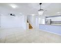 Bright open-concept living space with tile flooring, chandelier, and easy access to kitchen at 2120 Waterlily View St, Henderson, NV 89044