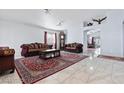 Spacious living room featuring marble floors, neutral walls, and elegant traditional-style furniture at 2419 Country Orchard St, North Las Vegas, NV 89030