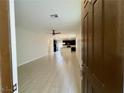 Open-concept living room boasts tile flooring and seamless transition into the modern kitchen at 4117 Midnight Crest Ave, North Las Vegas, NV 89031