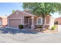 Inviting home featuring a covered porch, easy-care landscaping, and an attached two-car garage for convenient living at 5234 Panguitch Dr, Las Vegas, NV 89122