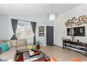 Cozy living space featuring neutral tile flooring, and access to front entry door, creating a welcoming atmosphere at 5234 Panguitch Dr, Las Vegas, NV 89122
