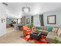 Bright living room boasts tile floors, neutral walls, and a modern chandelier, ideal for entertaining at 5234 Panguitch Dr, Las Vegas, NV 89122