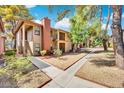 View of the building exterior showcasing manicured grounds and walkway at 5576 W Rochelle Ave # 9C, Las Vegas, NV 89103